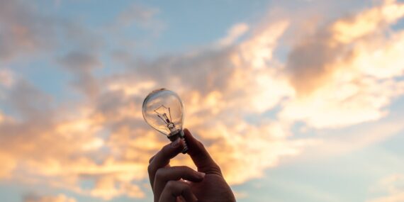 person holding clear light bulb