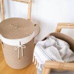 white and brown laundry basket on the floor