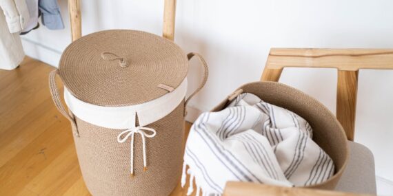 white and brown laundry basket on the floor
